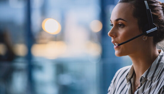 Cropped shot of an attractive young businesswoman wearing a headset and sitting alone in her office